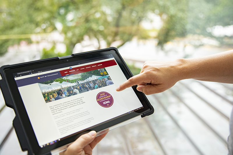 a person navigates through the Strategic Plan Dashboard website on a tablet